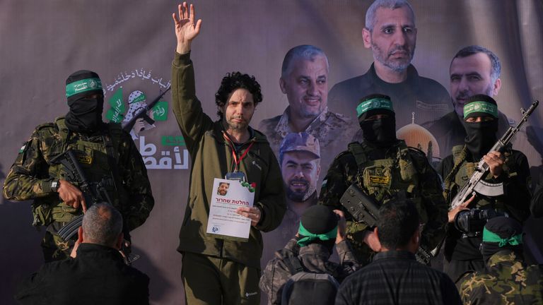 Israeli Ofer Kalderon who has been held hostage by Hamas in Gaza since October 7, 2023, waves before being handed over to the Red Cross by Hamas fighters in Khan Younis, southern Gaza Strip, Saturday Feb. 1, 2025. Photo/Abdel Kareem)