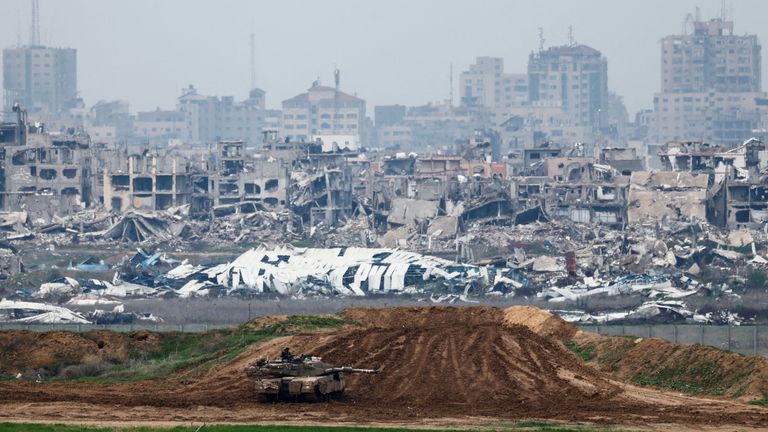 Israeli soldier sits on a tank at the border with Gaza. Pic: Reuters