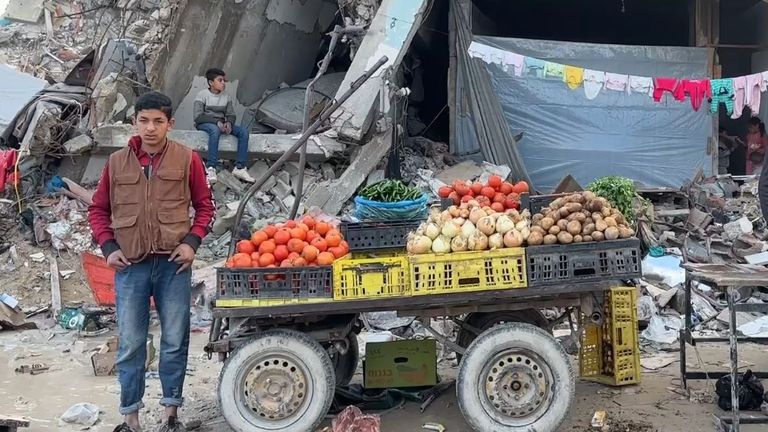 A veg stall in a devastated Gaza street