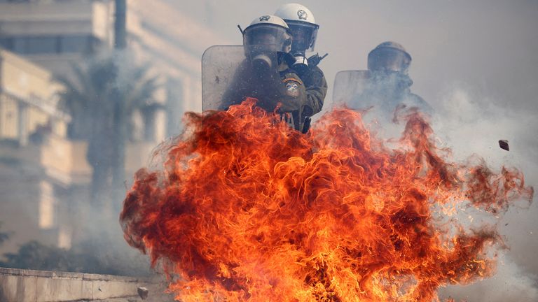 Riot police react to ignited Molotov cocktails thrown by demonstrators, at a protest near the Greek parliament, marking the second anniversary of the country's worst railway disaster, while an investigation continues, in Athens, Greece, February 28, 2025. REUTERS/Florion Goga TPX IMAGES OF THE DAY