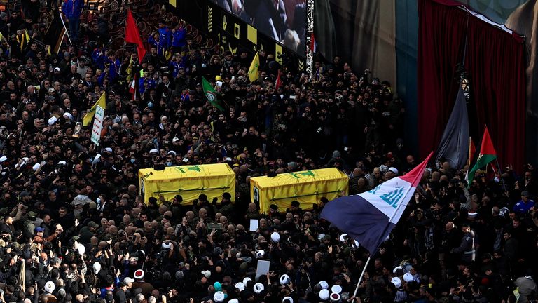 Hezbollah members carry the coffins of former Hezbollah leaders Hassan Nasrallah and Hashem Safieddine, who were killed in Israeli airstrikes last year, on the day of a public funeral ceremony, in Camille Chamoun Sports City Stadium, on the outskirts of Beirut, Lebanon February 23, 2025. REUTERS/Thaier Al-Sudani