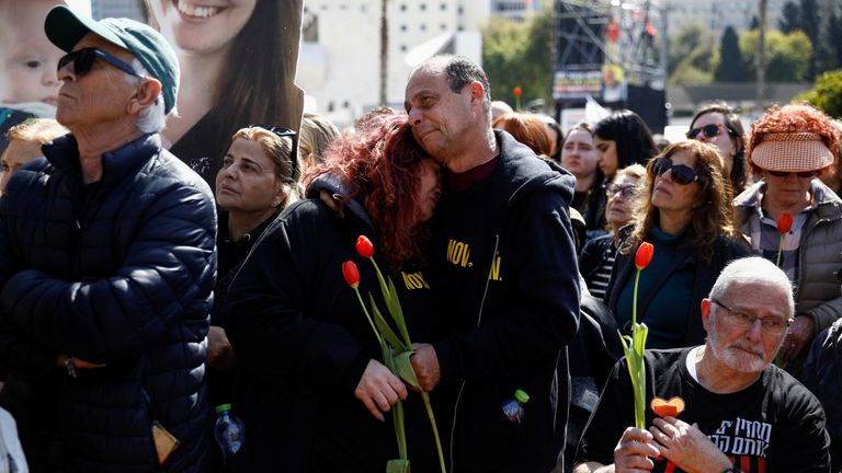 Israelis gather on the day of a funeral procession for Shiri, 32, and her two children, Kfir, 9 months old, and Ariel, 4, of the Bibas family, who were kidnapped from their home in Kibbutz Nir Oz, during the deadly October 7, 2023 attack by Hamas and then killed in Gaza, at a public square dedicated to hostages in Tel Aviv, Israel February 26, 2025. REUTERS/Shir Torem