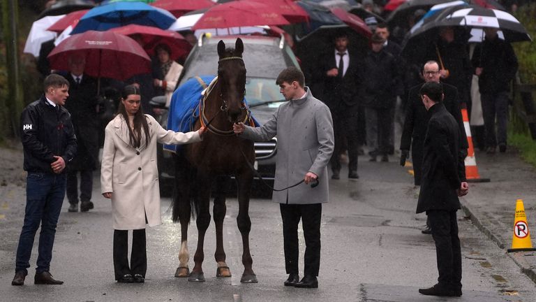 The hearse carrying the coffin of Michael O'Sullivan is lead by a horse away from the grounds following the funeral at St John the Baptist Church, Glantane. Jockey Michael O'Sullivan died as a result of the injuries he suffered in a fall at Thurles on February 6 at the age of 24. O'Sullivan started off his career on the point-to-point circuit and was crowned champion under-21 rider in 2019. Picture date: Wednesday February 19, 2025. PA Photo. See PA Story FUNERAL OSullivan. Photo credit should read: Brian Lawless/PA Wire...RESTRICTIONS: Use subject to restrictions. Editorial use only, no commercial use without prior consent from rights holder.