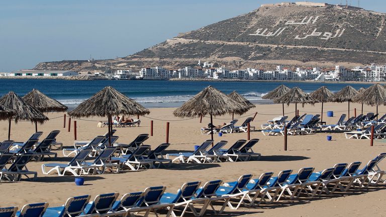 Empty beach chairs are seen at the Atlantic beach in Agadir, one of the host cities for the FIFA Club World Cup, December 12, 2013. The hill bears the inscription in Arabic "God, Country, King". REUTERS/Amr Abdallah Dalsh (MOROCCO - Tags: SPORT SOCCER SOCIETY)