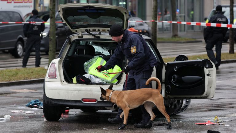 Police works with a sniffer dog at a car which drove into a crowd in Munich, Germany, February 13, 2025, injuring several people. REUTERS/Wolfgang Rattay