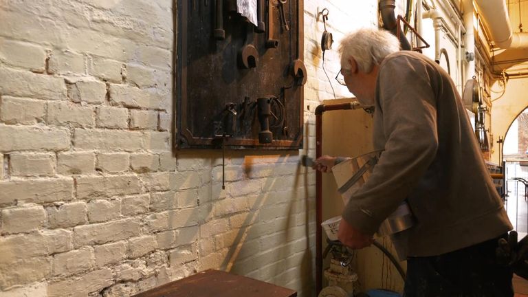 Man painting wall at museum