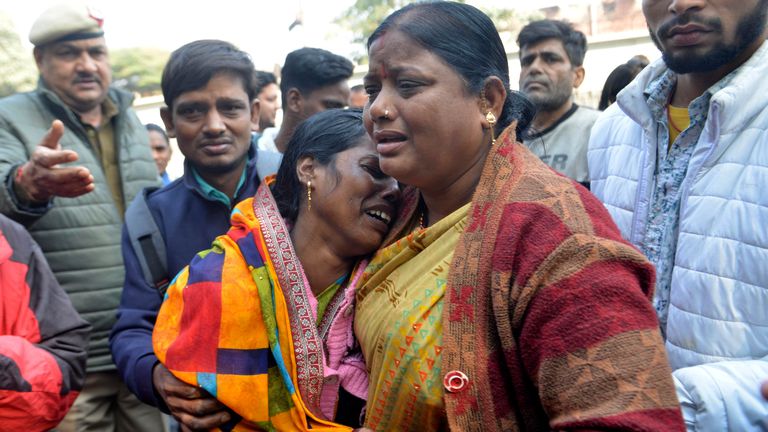 Relatives of a passenger who died during a stampede took place Saturday at New Delhi railway station, console each other as they wait to collect the body from a hospital, in New Delhi, India, Sunday, Feb.16, 2025. (AP Photo)