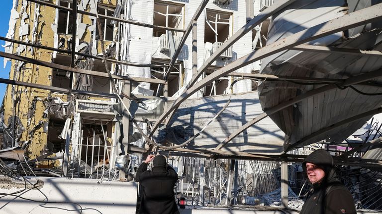 Residents stand at the site of a clinic hit by a Russian drone strike in Odesa.
Pic: Reuters