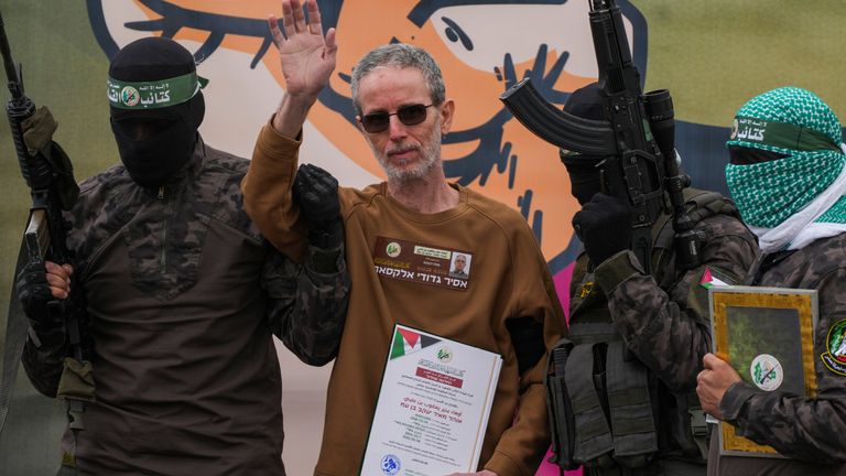 Israeli captive, Ohad Ben Ami waves as he is escorted by Hamas fighters. Pic: AP