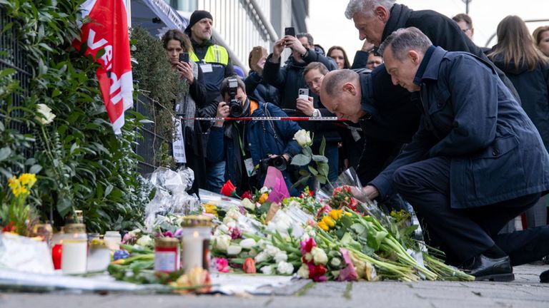 15 February 2025, Bavaria, Munich: Federal Chancellor Olaf Scholz (SPD), Munich's Lord Mayor Dieter Reiter (SPD) and Federal Transport Minister Volker Wissing (non-party) (l-r) lay down white roses at the site where a car crashed into a Ver.di demonstration on February 13. Many questions remain unanswered after the attack in Munich, which left 39 people injured. Investigators have so far assumed an Islamist motive. Pic: AP