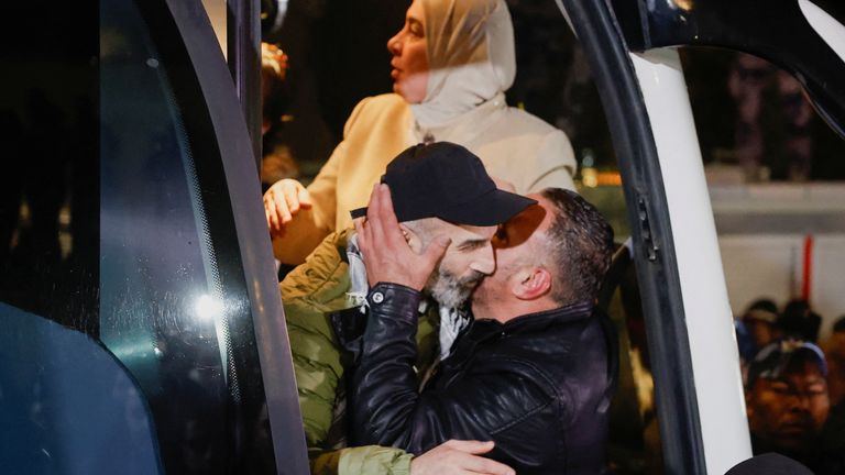 People embrace as Palestinian prisoners arrive in Ramallah, in the Israeli-occupied West Bank. Pic: Reuters