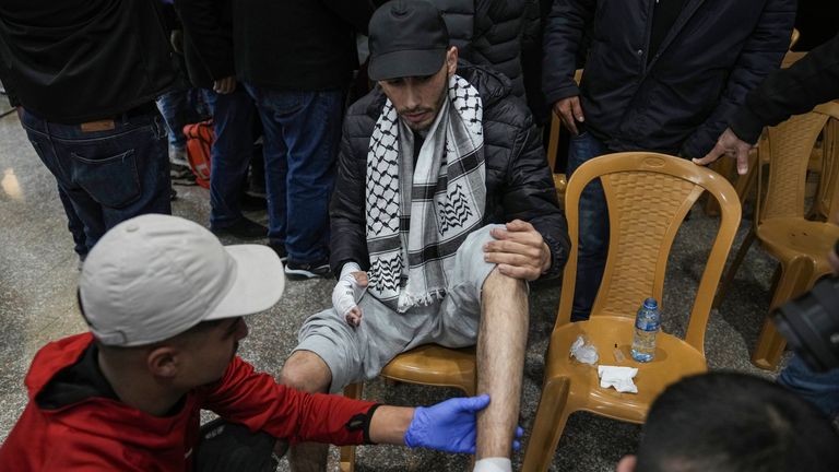 A Palestinian prisoner is checked by medical personnel after being released from Israeli prison as a result of a ceasefire agreement between Israel and Hamas. Pic: AP