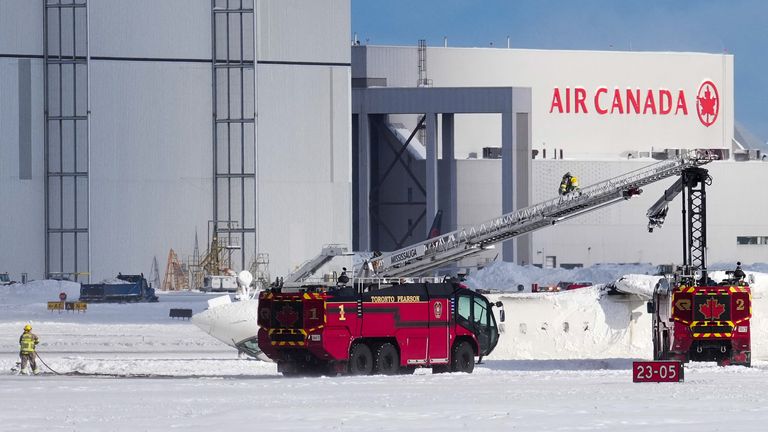 First responders work at the Delta Air Lines plane crash site at Toronto Pearson International Airport in Mississauga, Ontario, Canada February 17, 2025. REUTERS/Arlyn McAdorey