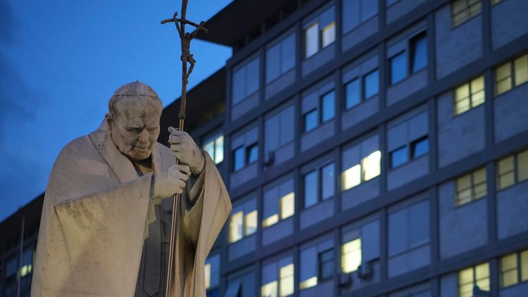 A statue of Pope John Paul II is seen in front of the Agostino Gemelli Polyclinic in Rome, Friday, Feb. 14, 2025, where Pope Francis has been hospitalized to undergo some necessary diagnostic tests and to continue his ongoing treatment for bronchitis. Pic: AP