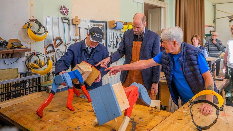  Prince William, The Duke of Rothesay stands alongside Alex Campbell and Derek Stewart who show him how to make a ''Tree-Hugger'' at the Carnoustie and Monifieth Men's Shed, Scotland, Britain, 6th February 2025.   Steve MacDougall/Pool via REUTERS