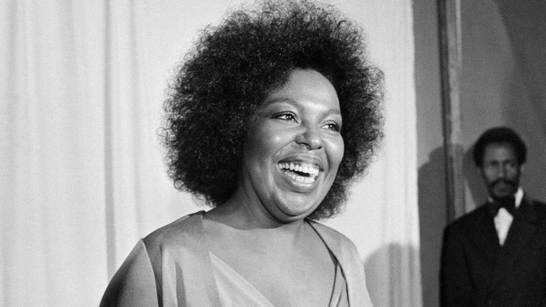 Roberta Flack holds the Grammy award for her record,  "Killing Me Softly With His Song" on Monday, March 4, 1974 at the 16th annual Grammy Awards, held at the Hollywood Palladium in Los Angeles, California. She also was named best female pop peformar of the year. Singer Isaac Hayes smiles in the background on the right. (AP Photo/Harold Filan)