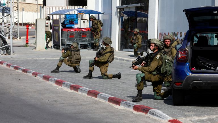 Israeli soldiers work to secure residential areas following a mass-infiltration by Hamas gunmen from the Gaza Strip, in Sderot, southern Israel October 7, 2023. REUTERS/Ammar Awad