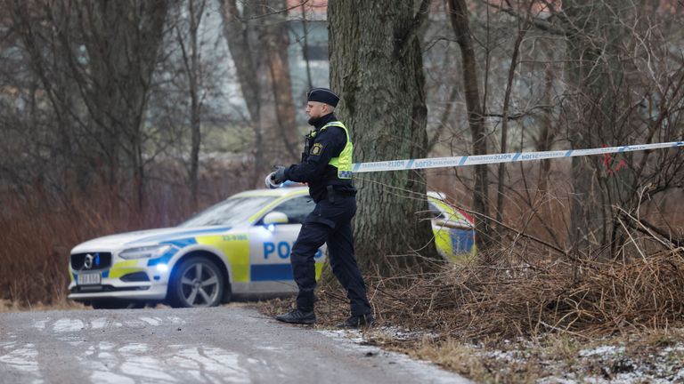 A police officer unrolls police tape at Risbergska School in Orebro, Sweden.
Pic:TT News Agency/Kicki Nilsson/Reuters