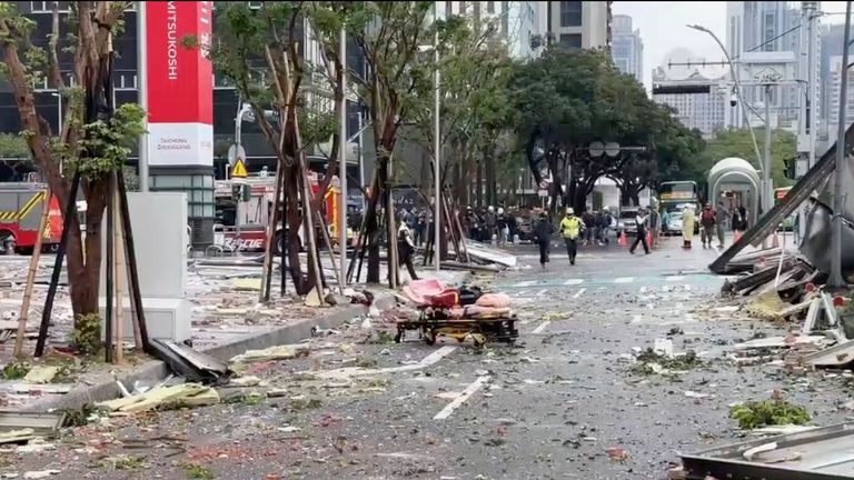 This image taken from video by Taiwan's TVBS shows the debris are strewn across the streets in the aftermath of an explosion at the Shin Kong Mitsukoshi department store in Taichung city in Taiwan on Thursday, Feb. 13, 2025. (TVBS via AP )