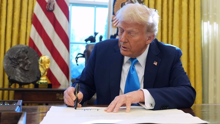 President Donald Trump signs a document in the Oval Office of the White House, Tuesday, Feb. 4, 2025, in Washington. (AP Photo/Evan Vucci)