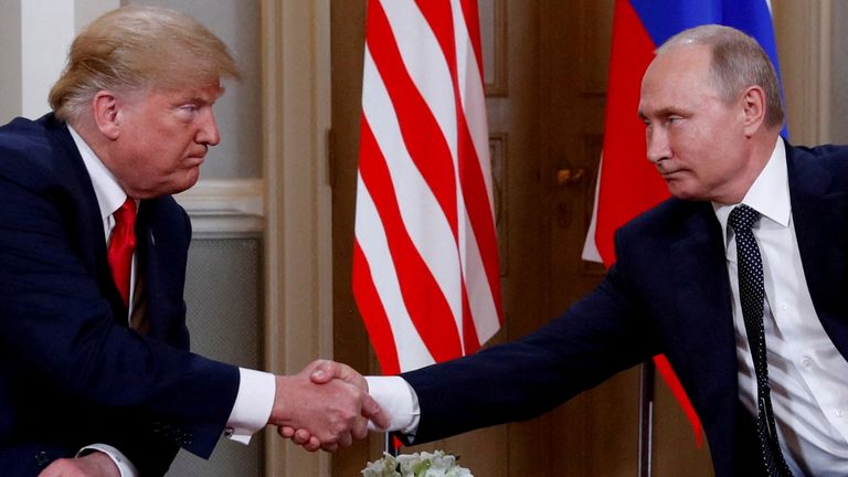 President Donald Trump and Russian President Vladimir Putin shake hands as they meet in Helsinki, Finland, July 16, 2018. REUTERS/Kevin Lamarque/File photo
