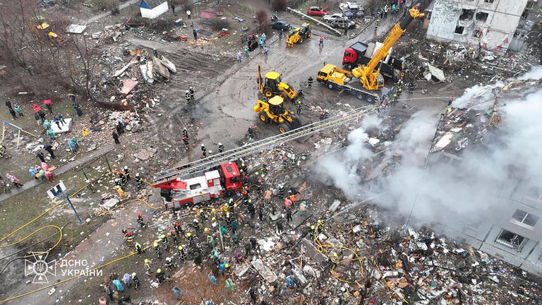 Firefighters at the scene of a rocket attack on a building in Poltava, Ukraine on Saturday. Pic: AP