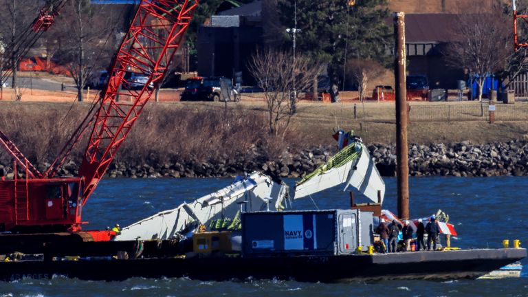 A crane retrieves part of the airline wreckage from the Potomac River. Pic: Reuters