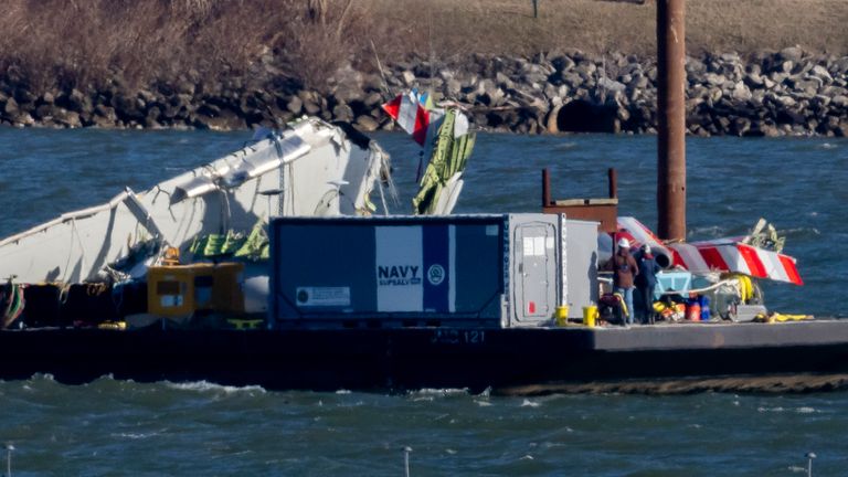 A piece of wreckage is lifted from the water onto a salvage vessel, near the site in the Potomac River of a mid-air collision between an American Airlines jet and a Black Hawk helicopter, at Ronald Reagan Washington National Airport, Tuesday, Feb. 4, 2025, in Arlington, Va. (AP Photo/Ben Curtis)