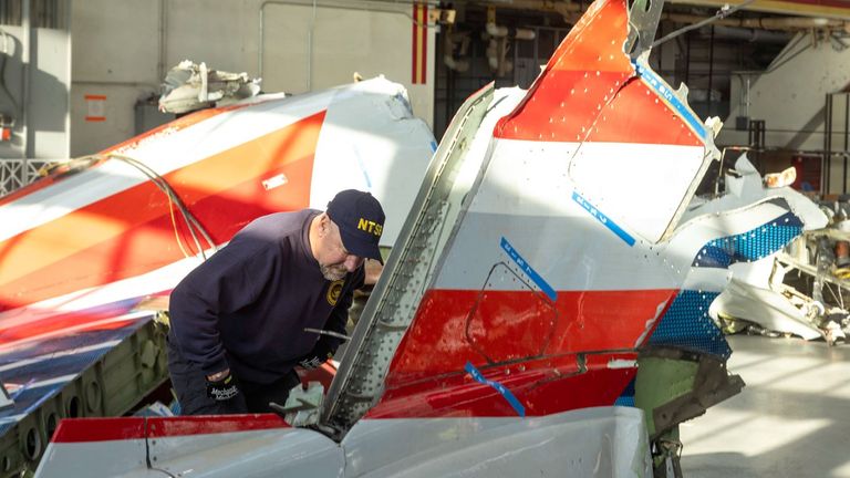 An investigator inspects wreckage from the crash. Pic: NTSB