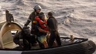 In this photo provided by the Australian Defense Force Australian Navy sailors from HMAS Choules used an inflatable boat to rescue Lithuanian rower Aurimas Mockus, second right, Monday, March 3, 2025, who struck a storm in the Coral Sea off the northeast coast of Australia while attempting to cross the Pacific Ocean from California. (CPOIS Helen Frank/Australian Defense Force via AP)