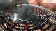 Smoke bombs and flares are released in parliament, in Belgrade, Serbia.
Pic: RTS Serbia/AP