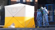 Forensic officers at the scene in Brixton Road.
Pic: PA