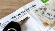 A vehicle tax reminder document of a desk with car keys and money. Pic: iStock