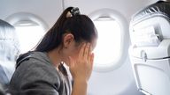 A young woman on a plane suffering from sickness. Pic: iStock