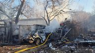 Firefighters work at a site of a Russian missile strike in Kharkiv.
Pic: Reuters