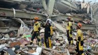 Chinese rescuers looks at a collapsed building before conducting a search and rescue operation in Mandalay. Pic: Myo Kyaw Soe/Xinhua via AP)