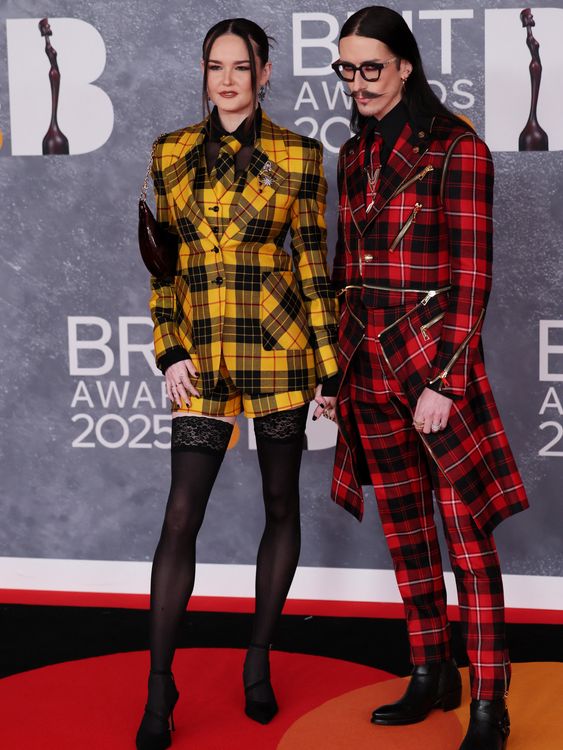 Fashion designer Joshua Kane with his wife Lottie - really working the contrasting tartan. Pic: Reuters