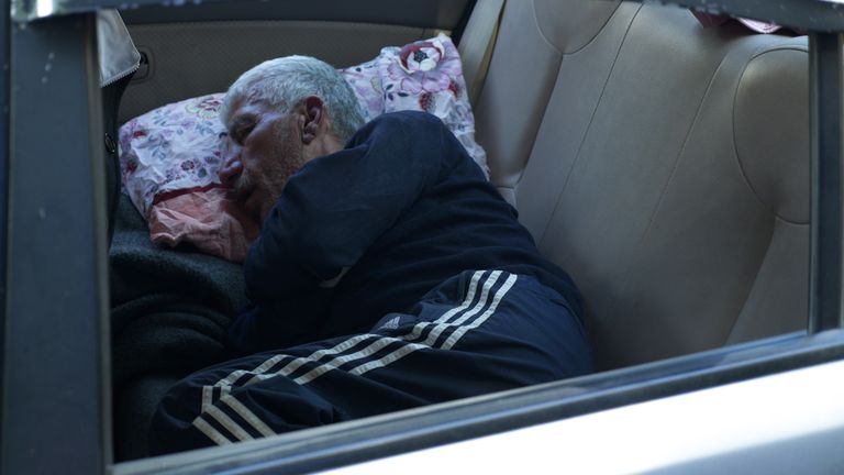 man sleeping in car  SN eyewitness from Stuart Ramsay about Syrian Alawites which features:  Hmeimim air base, home to the Russian military in Syria; mass grave in Al-Sanobar; head of General Security, Mustafa Kunefate; various GVs of locals and case studies  