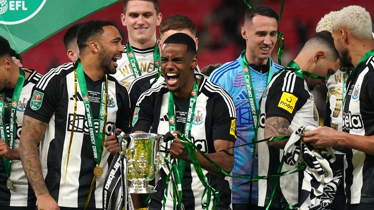 Alexander Isak lifts the Carabao Cup trophy after Newcastle's victory over Liverpool on Sunday. Pic: PA