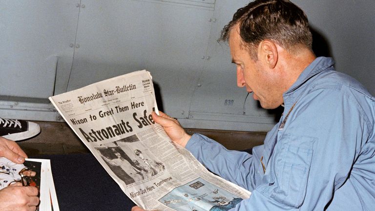 Astronaut James Lovell, Apollo 13 mission commander, reads a newspaper account of his mission. File pic: NASA