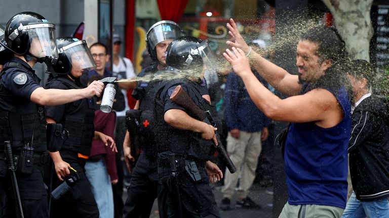 A police officer uses a crowd control spray on a demonstrator, as football fans join the weekly protest of retirees against Argentinian President Javier Milei's adjustment policies, in Buenos Aires, Argentina March 12, 2025. REUTERS/Agustin Marcarian TPX IMAGES OF THE DAY