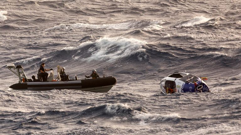 In this photo provided by the Australian Defense Force Australian Navy sailors from HMAS Choules use an inflatable boat to rescue Lithuanian rower Aurimas Mockus, Monday, March 3, 2025, who struck a storm in the Coral Sea off the northeast coast of Australia while attempting to cross the Pacific Ocean from California. (CPOIS Helen Frank/Australian Defense Force via AP)