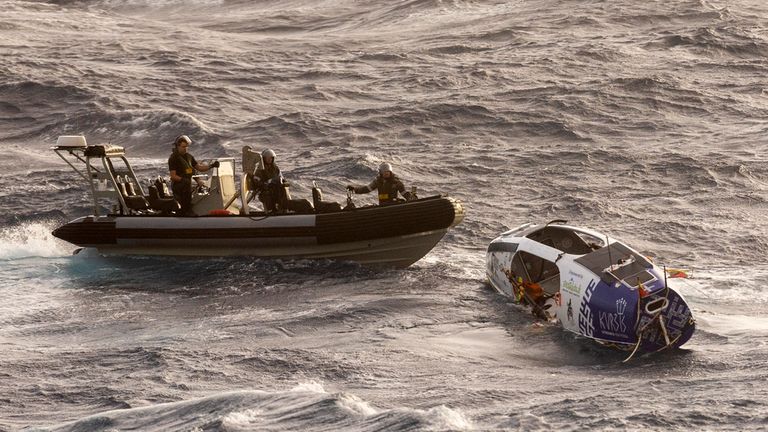 In this photo provided by the Australian Defense Force Australian Navy sailors from HMAS Choules use an inflatable boat to rescue Lithuanian rower Aurimas Mockus, Monday, March 3, 2025, who struck a storm in the Coral Sea off the northeast coast of Australia while attempting to cross the Pacific Ocean from California. (CPOIS Helen Frank/Australian Defense Force via AP)