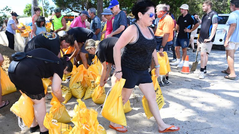 The residents collecting sandbags in a deposit on the island of Bribie in Queensland. Pic: AP