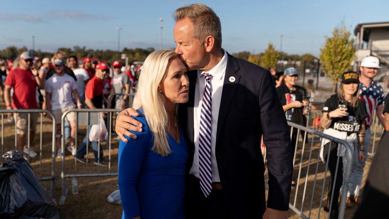 U.S. Representative Marjorie Taylor Greene (R-GA) is kissed by her boyfriend Brian Glenn, Programming Director of Right Side Broadcasting Network (RSBN), as they attend a campaign rally for Republican presidential nominee and former U.S. President Donald Trump in Macon, Georgia U.S., November 3, 2024. REUTERS/Cheney Orr TPX IMAGES OF THE DAY