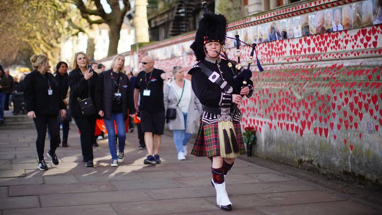 A bagpiper at a ceremony - events across the country included music, poems and readings. Pic: PA