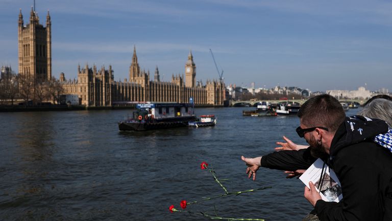 Flowers are thrown into the River Thames. Pic: Reuters