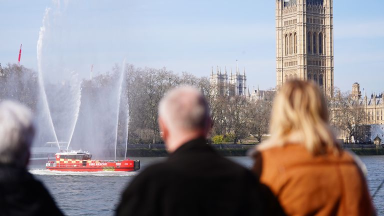 A fire boat performs a water salute. Pic: PA