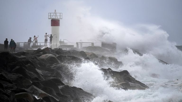 The waves crash into rocks in the middle of strong winds on the Gold Coast on Monday. Pic: AP