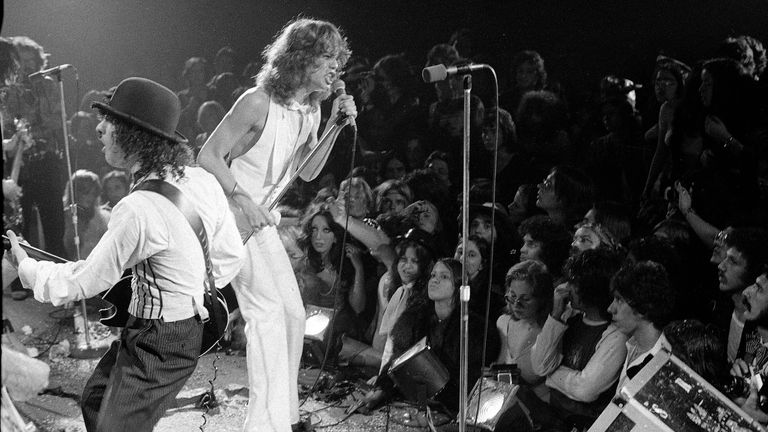 Rock group "The New York Dolls" perform at the Waldorf Halloween Ball, Waldorf-Astoria Hotel, NYC, Oct. 31, 1973. At right is lead singer David Johansen, with guitarist Sylvain Sylvain. (AP Photo/Richard Drew)